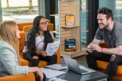 Students chatting in library.