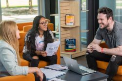 students chatting in library