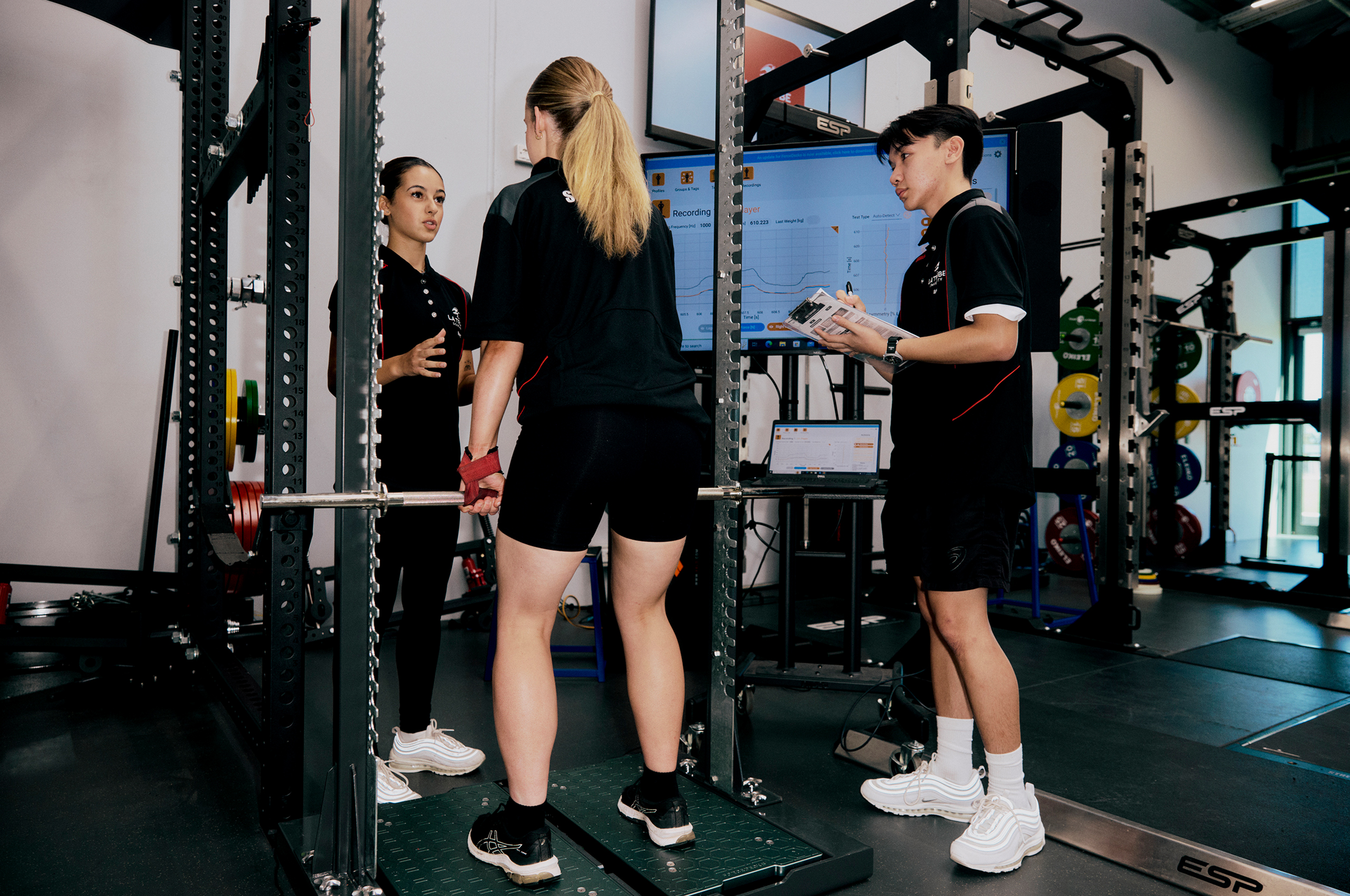 Students using exercise equipment at La Trobe Sports building.