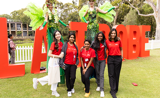 Students standing in front of La Trobe signage at O Week